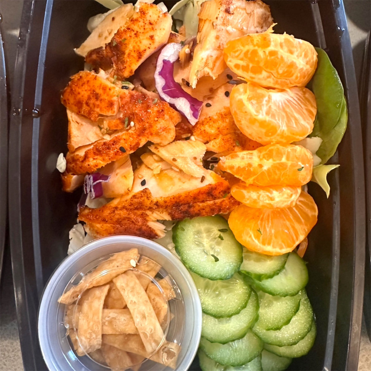 Nourish Your Adventure Honey Ginger Salmon Salad with clementines and cucumber