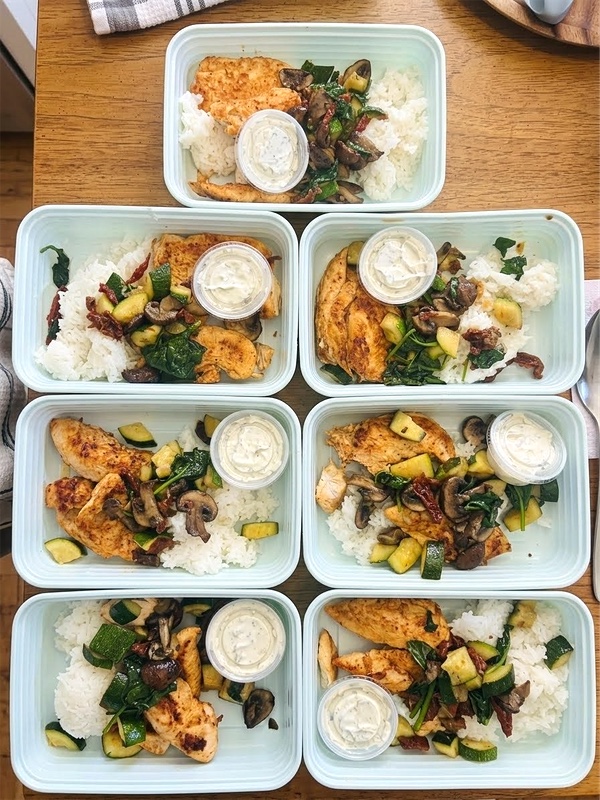 Seven prepared NYA Mediterranean chicken meals with rice, vegetables, and tzatziki